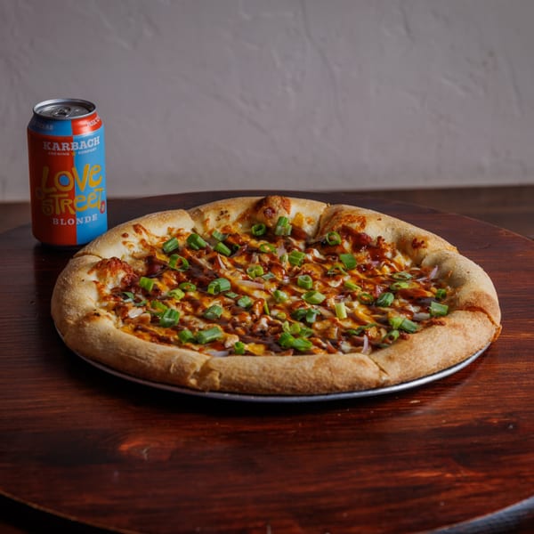 The Heights Pizzeria's BBQ chicken pizza with green onions and a Karbach Love Street Blonde beer.